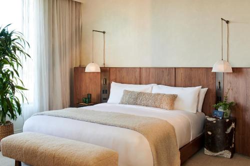 a bedroom with a large bed and a large window at 1 Hotel Seattle in Seattle