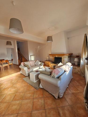 a living room with two couches and a fireplace at KlaireyBelles in Dáfia