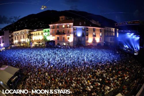 a large crowd of people at a concert at night at Locarno Center - Free Parking, Netflix and WiFi in Locarno