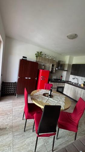 a kitchen with a wooden table and red chairs at Vita sul Garda in Bardolino