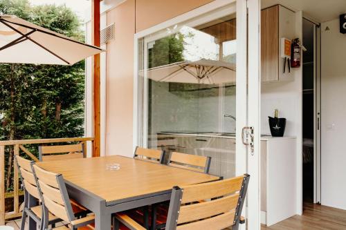 a dining room with a table and chairs at Camping Del Sole Village in Iseo