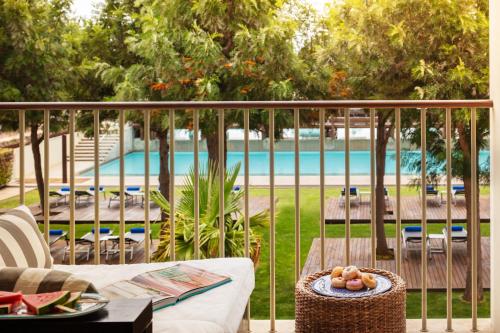 a balcony with a view of a swimming pool at Victoria Golf Resort and Spa Managed by Accor in Vilamoura