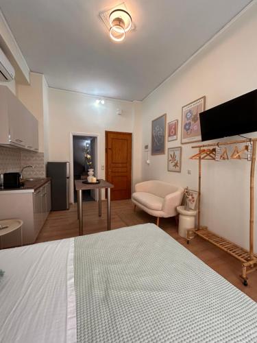 a bedroom with a bed and a living room with a kitchen at Aurora Apartments in Mytilini