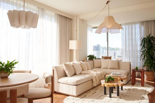 a living room with a couch and a table at 1 Hotel Seattle in Seattle