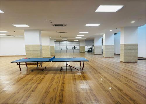 a large room with two ping pong tables in it at Housr Sector 28 Gurgaon Near IFFCO Chowk Metro Station in Gurgaon
