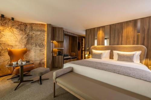 a hotel room with a large bed and a desk at Idou Malabata Beach and SPA in Tangier