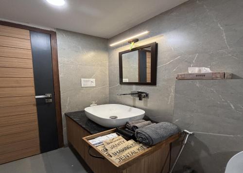 a bathroom with a sink and a toilet and a mirror at Housr Sector 28 Gurgaon Near IFFCO Chowk Metro Station in Gurgaon