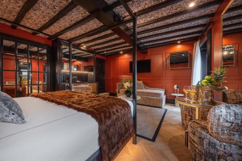a bedroom with a large bed and a living room at Pantheon Suite - Residenze di Charme in Rome
