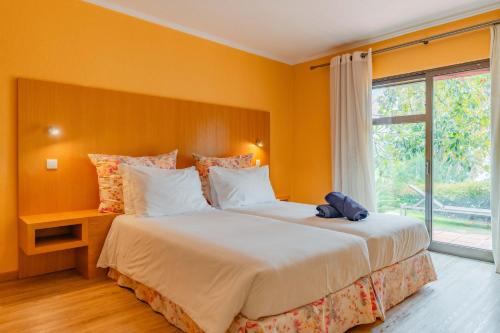 Ένα ή περισσότερα κρεβάτια σε δωμάτιο στο Quinta Splendida Wellness & Botanical Garden