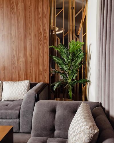 a living room with a couch and a plant at Villa Misk Alkhobar in Al Khobar