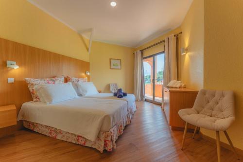 Ένα ή περισσότερα κρεβάτια σε δωμάτιο στο Quinta Splendida Wellness & Botanical Garden