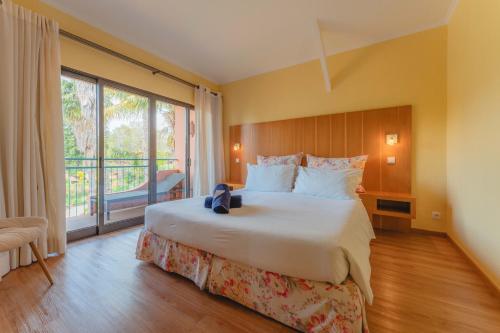 Ένα ή περισσότερα κρεβάτια σε δωμάτιο στο Quinta Splendida Wellness & Botanical Garden