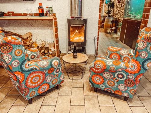 a living room with two chairs and a fireplace at Hotel H in Granollers