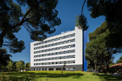 a white building with a lot of windows at ibis budget Madrid Aeropuerto in Madrid
