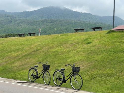 two bikes parked on the side of a road at Ang Kaew Pool Villa 4BR 5 Min Drive to Nimmanhemin in Chiang Mai