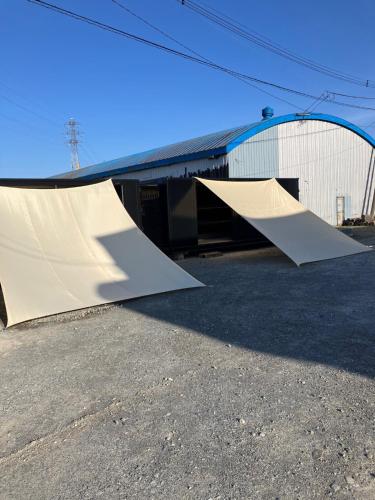 a skateboard ramp sitting next to a building at TrainLineField in Tōbetsu