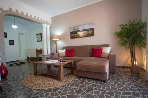 a living room with a couch and a table at Enetiko Apartments in Chios