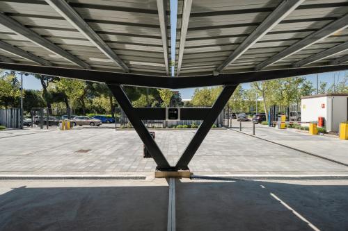 a view of a parking lot with a metal roof at ibis budget Madrid Aeropuerto in Madrid