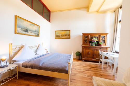 a bedroom with a bed and a desk at Schloss Arenfels in Bad Hönningen