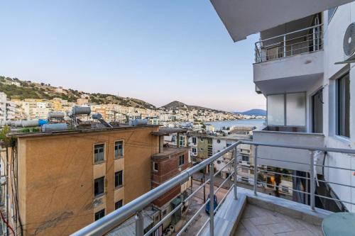 a balcony of a building with a view of the water at Seaview Apartment in the Center of Saranda in Sarandë