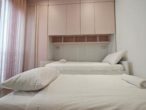 two beds in a room with white cabinets at BluSky in Safi