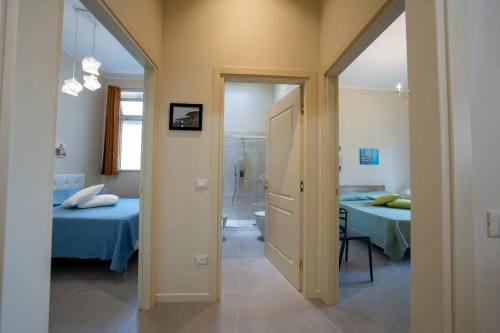 a hallway leading to a room with two beds at CHIC house in Cascina