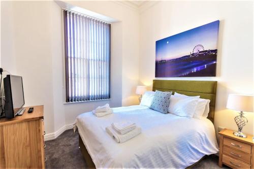 a bedroom with a bed and a television in it at The Buckingham Suite in Plymouth