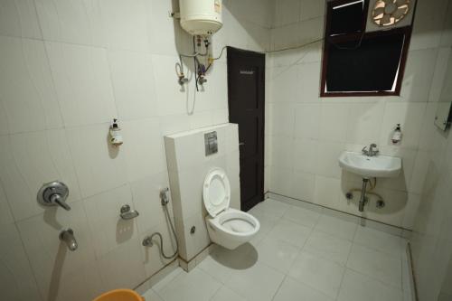 a bathroom with a toilet and a sink at The Paramant Near Delhi IGI Airport in New Delhi