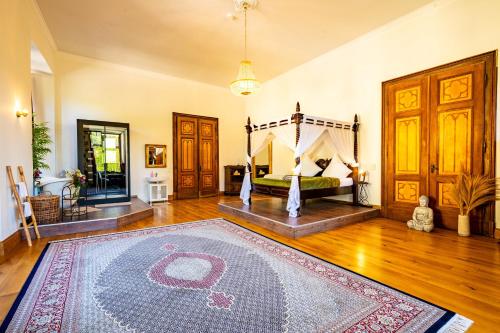 a bedroom with a bed and a rug on a wooden floor at Schloss Arenfels in Bad Hönningen
