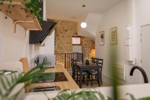 a kitchen and dining room with a table and chairs at Le Troglochill in Belvès