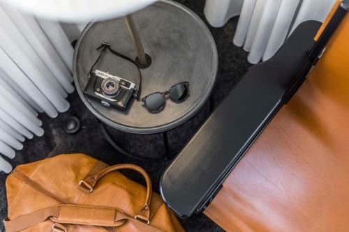 a table with a bowl with a camera and a bag at Scandic The Mayor in Aarhus