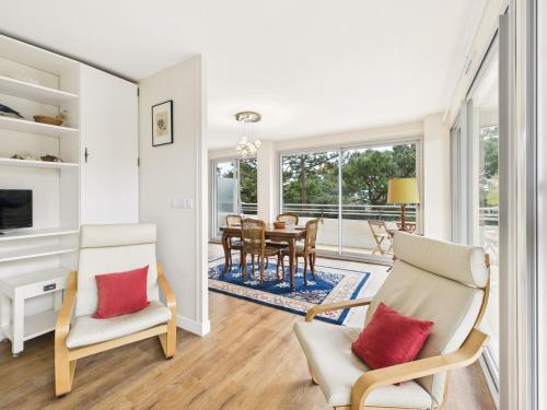 un salon avec des chaises et une salle à manger avec une table dans l'établissement 120 m de la plage- Appartement pour 4 - balcon, à La Baule