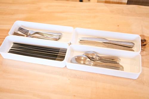 two plastic containers filled with utensils on a table at LEVATA in Nasu