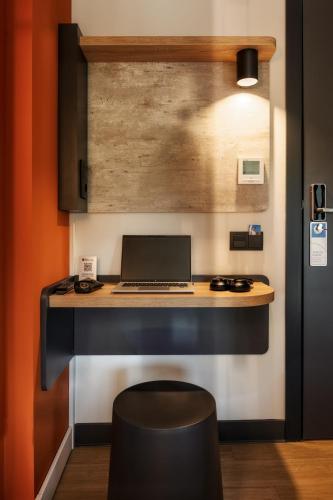 a kitchen with a desk with a laptop on it at ibis budget Madrid Aeropuerto in Madrid