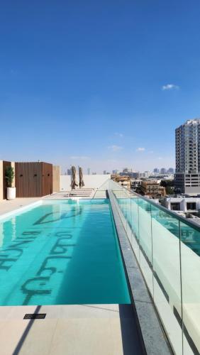 a swimming pool on the roof of a building at Disalvo Smart and Luxury Studio in Dubai