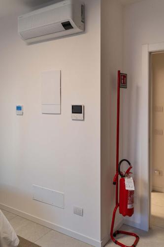 a white wall with a red fire hydrant in a room at Monolocale Margherita - Cascina Da Rosa in Capiago Intimiano