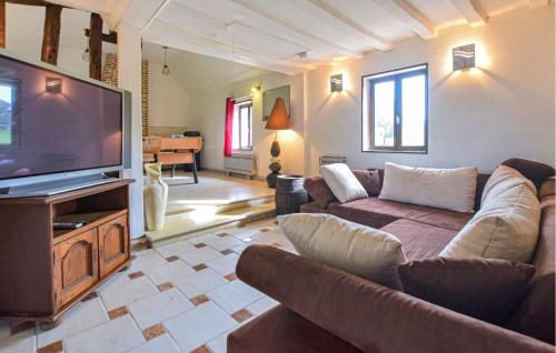 a living room with couches and a flat screen tv at 3 Bedroom Amazing Home In Grandmesnil in Le Renouard