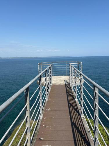 a wooden boardwalk over the ocean with a view at What a view Mevagissey in Mevagissey