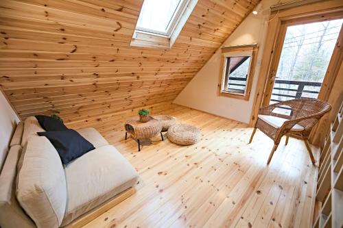 a bedroom with a bed and a wooden wall at LEVATA in Nasu