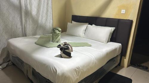 a bed with a doll sitting on top of it at Dewclaw Baobob Safari Lodge in Mfuwe