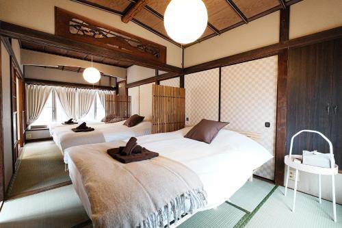 a bedroom with three beds and a table at Traditional Japanese House in Wada