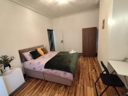 a bedroom with a bed and a desk at Double-Bedroom in the Heart of Harpurhey Manchester A1 Perfect for Short Stays in Manchester