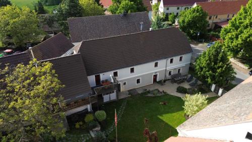 an overhead view of a large white house with a yard at Penzion Pršutérie® in Litoměřice