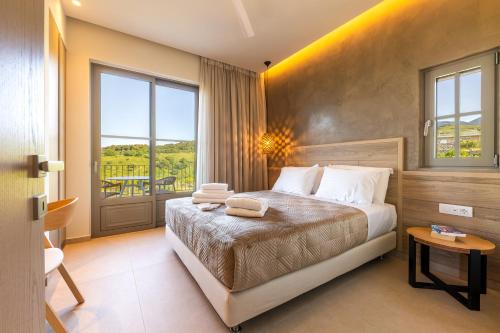 a hotel room with a bed and a large window at Casa Tierra - Villa II in Kos Town