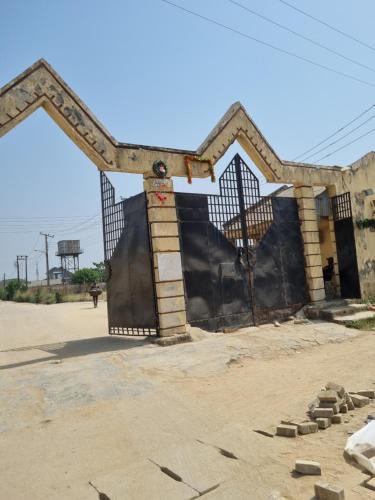 an open gate to a building in the desert at Luxury & Secured 3 Bedroom House with 24 Hours Solar Light in Ikorodu