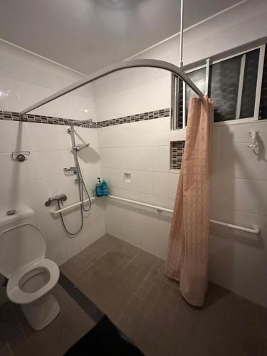 a bathroom with a shower and a toilet at Peaceful Queen Room in Cozy Garden House - KV4 in Kellyville