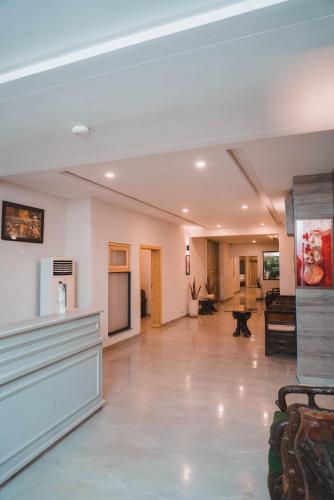 a large living room with a couch and a table at The Garden Hotel in Islamabad
