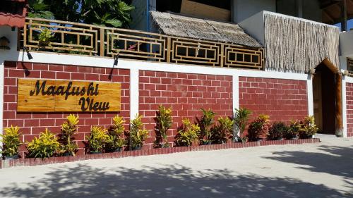 a brick wall with a sign that reads matatuatownatown view at Maafushi View in Maafushi