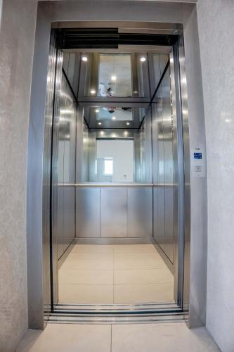 an elevator in a building with a glass door at Penthouse Olivia Međugorje - Private Jacuzzi in Međugorje