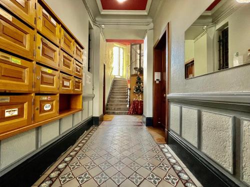 a hallway with a tile floor and a staircase at Le Bastille, 6 pers, 300 m gare, Climatisation in Grenoble